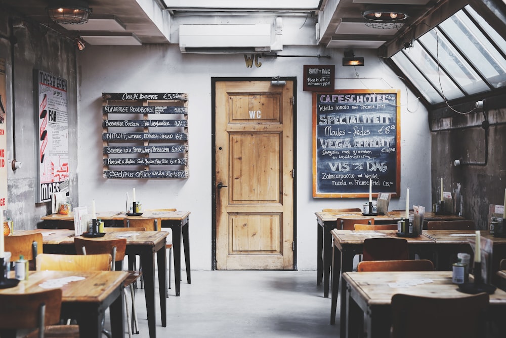 brown wooden door between table and chairs