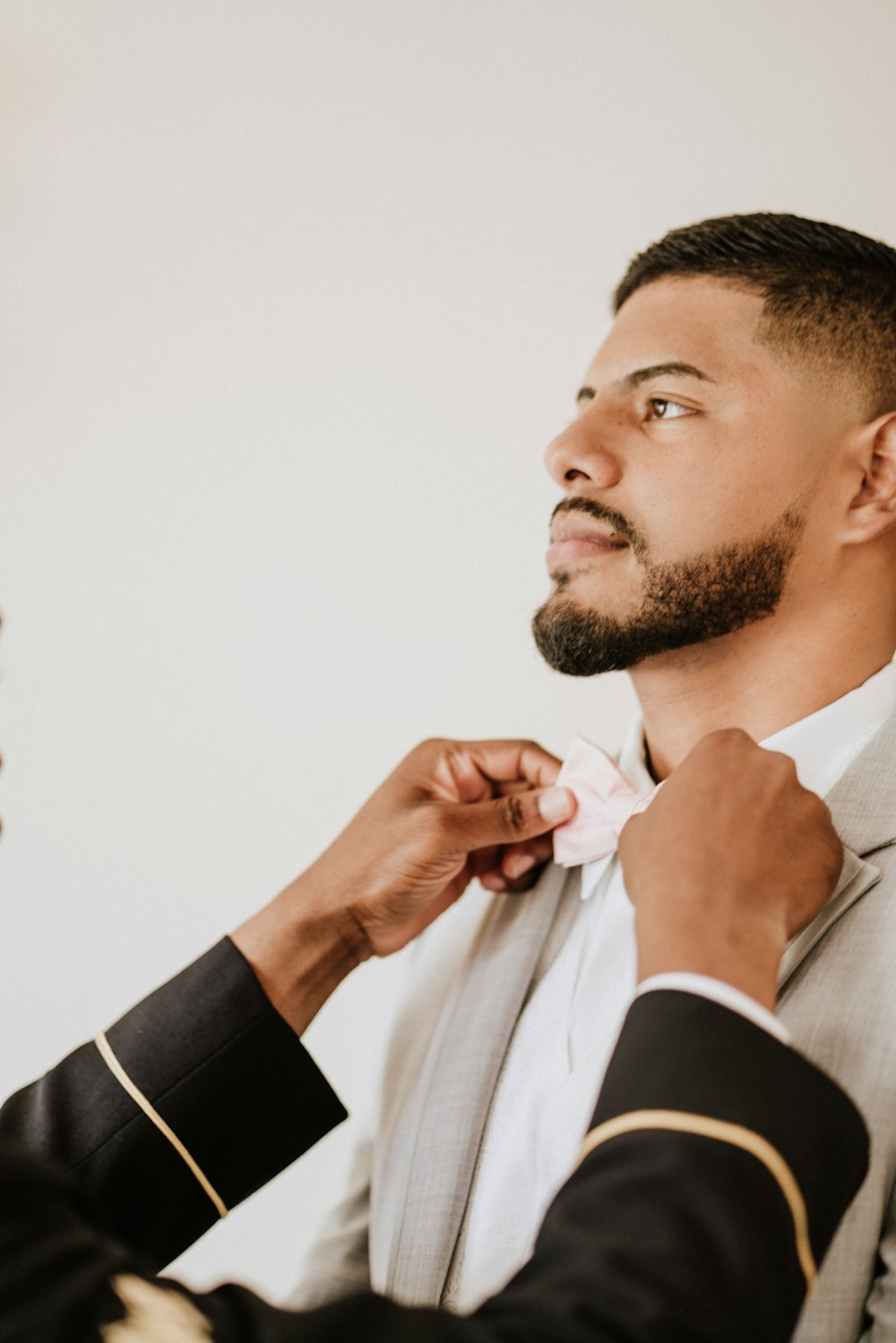 man in white coat and bowtie