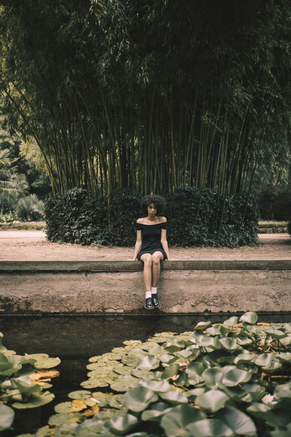 woman sitting on black canal frame