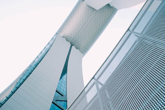 person showing white concrete building in Marina Bay Singapore