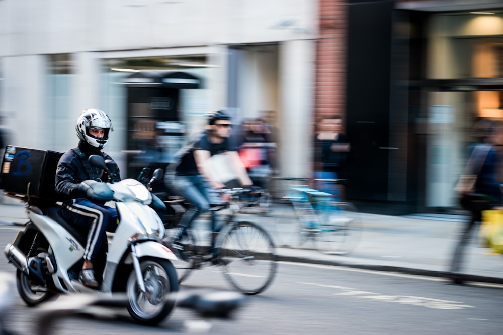 panning photography of motorcycle on road