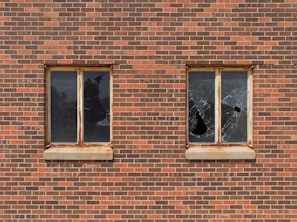 two broken glass building windows