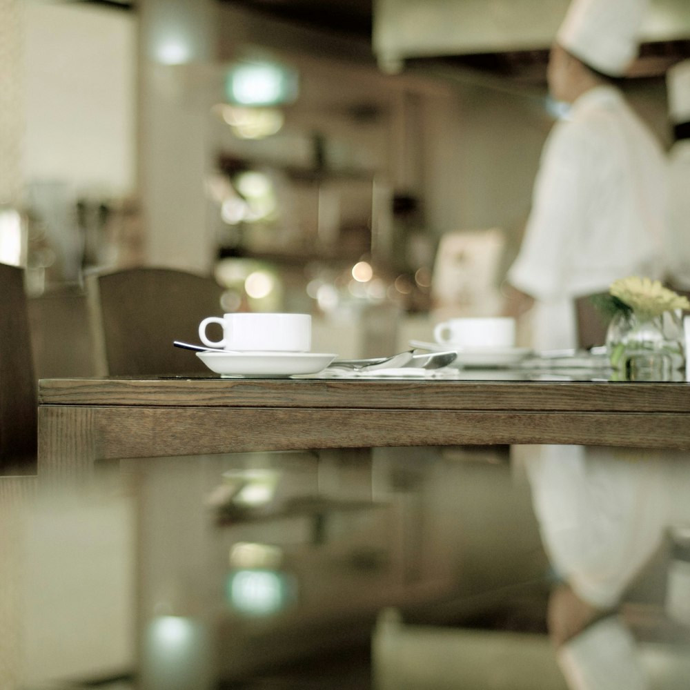 selective focus photography of teacup on top of table