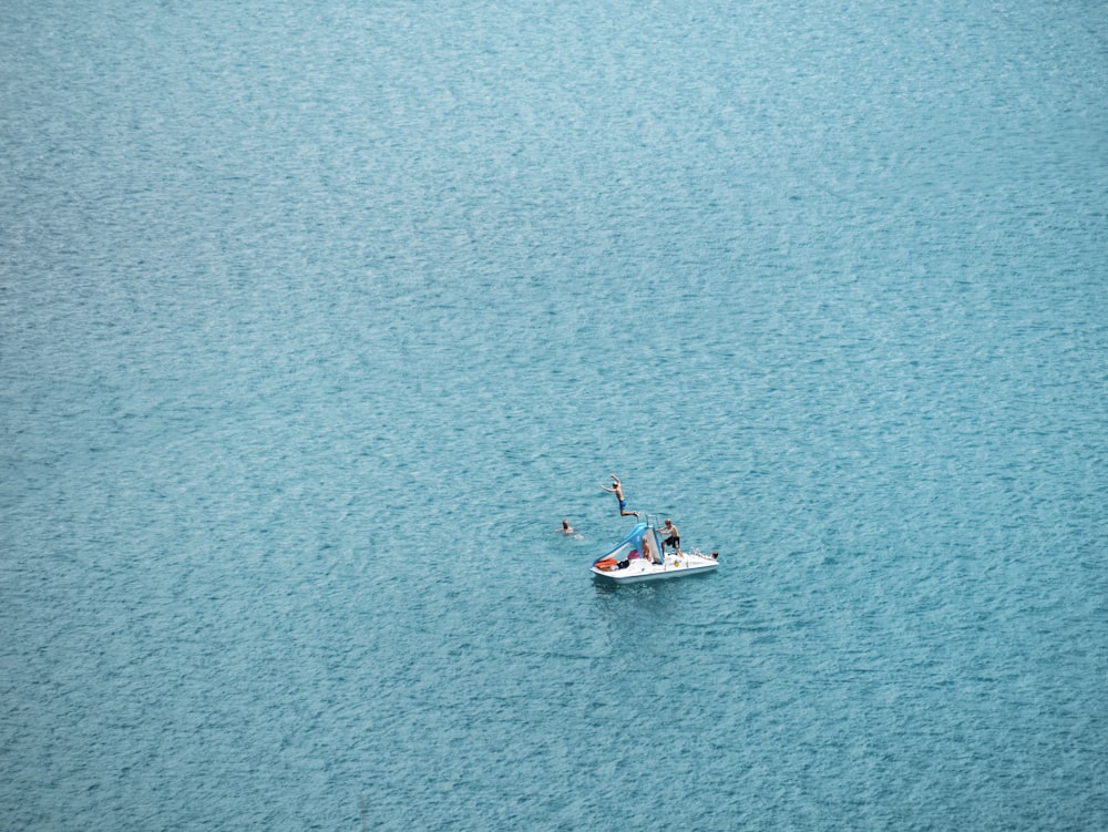 people jumping on boat