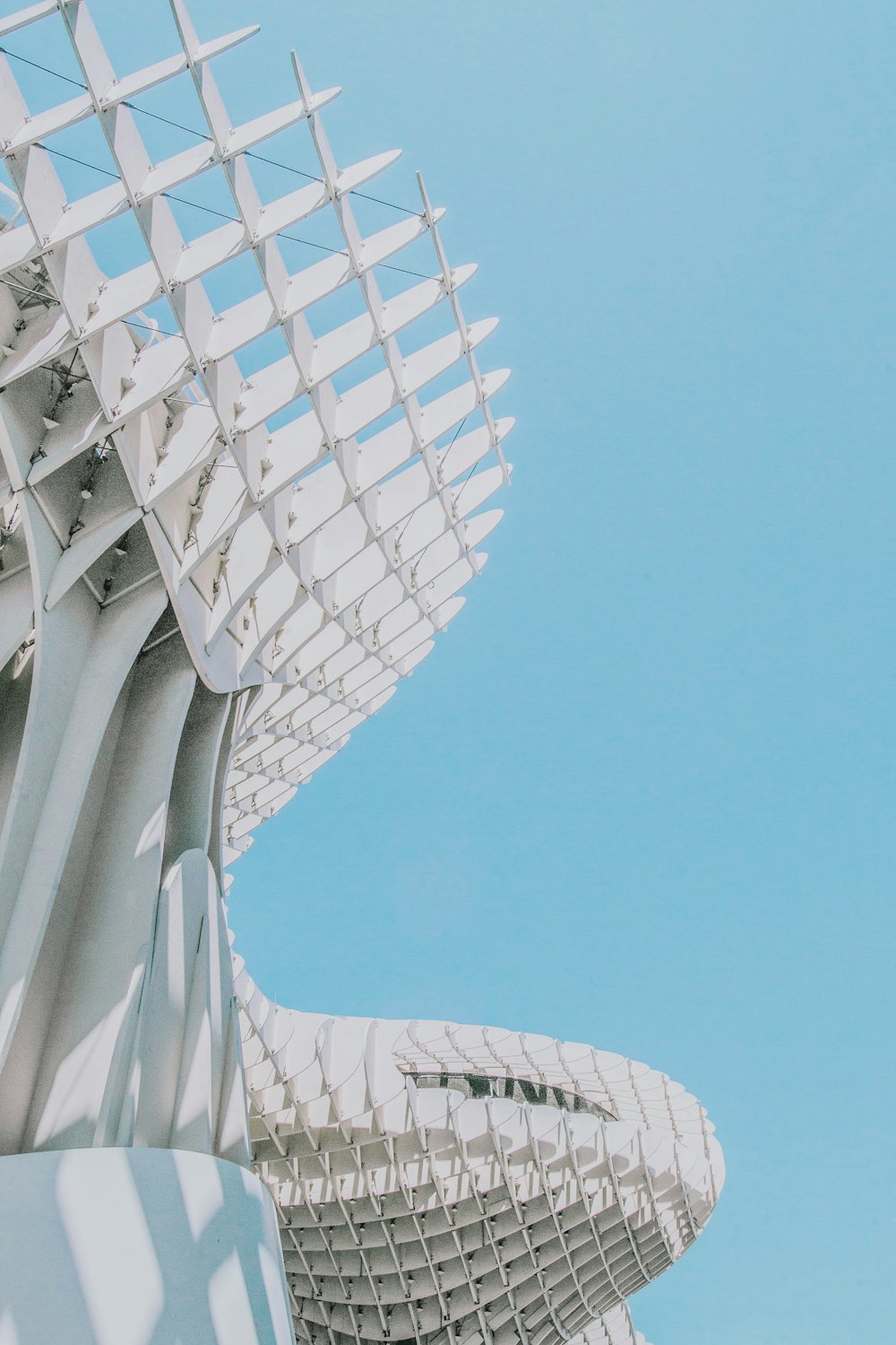 architectural photography of white building under blue skies