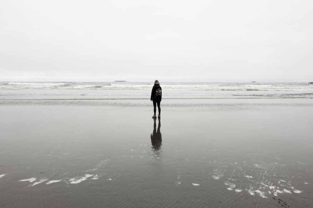 person standing near sea at daytime