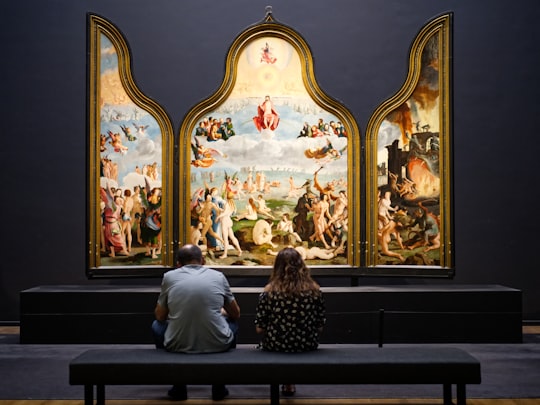 man sitting on bench in Rijksmuseum Netherlands