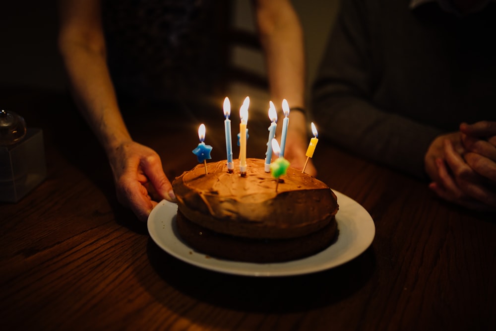 lit candles on chocolate cake