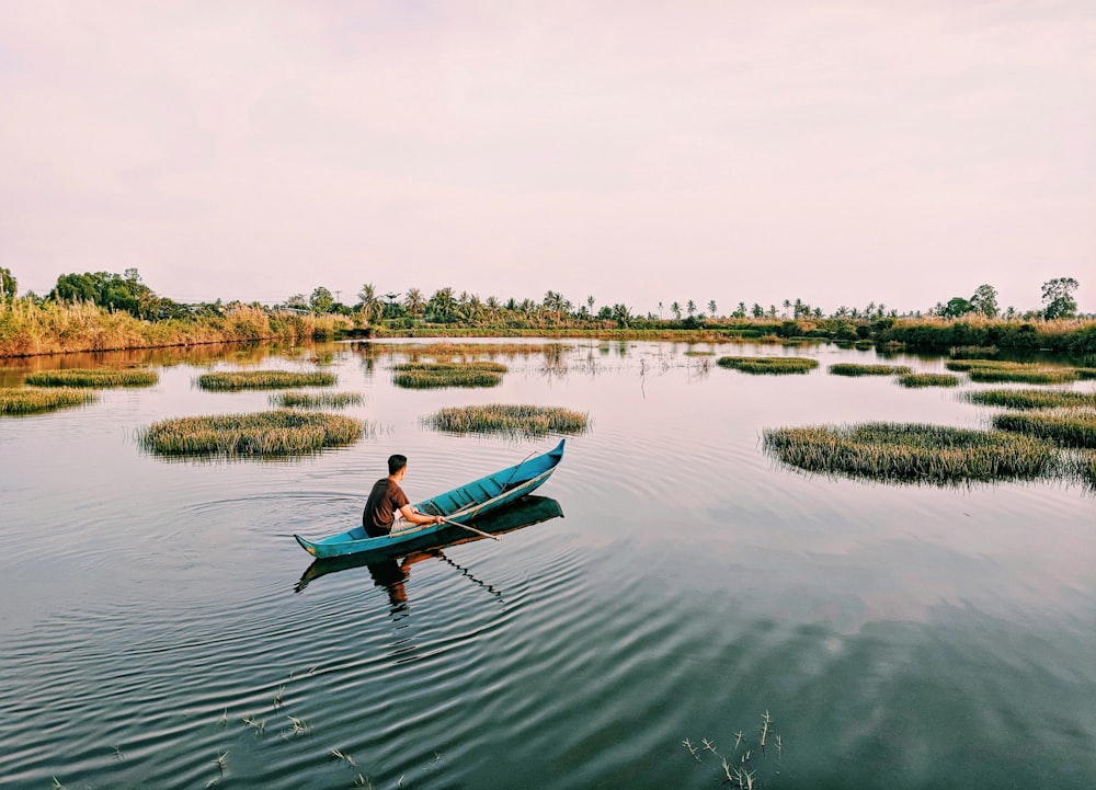 man sailing on body of water