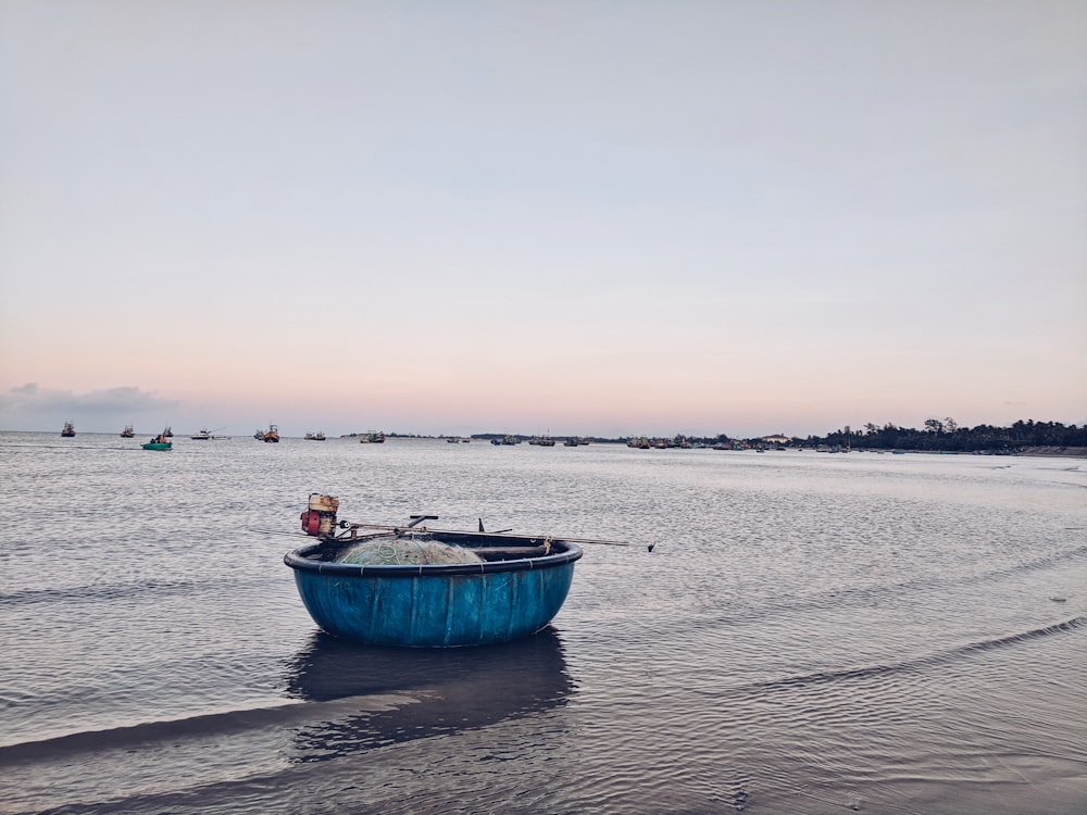 blue boat on body of water