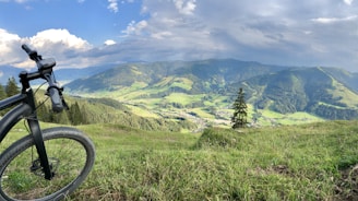 A scenic view of mountains with a bike parked.