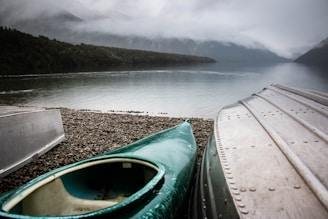 green kayak near body of water
