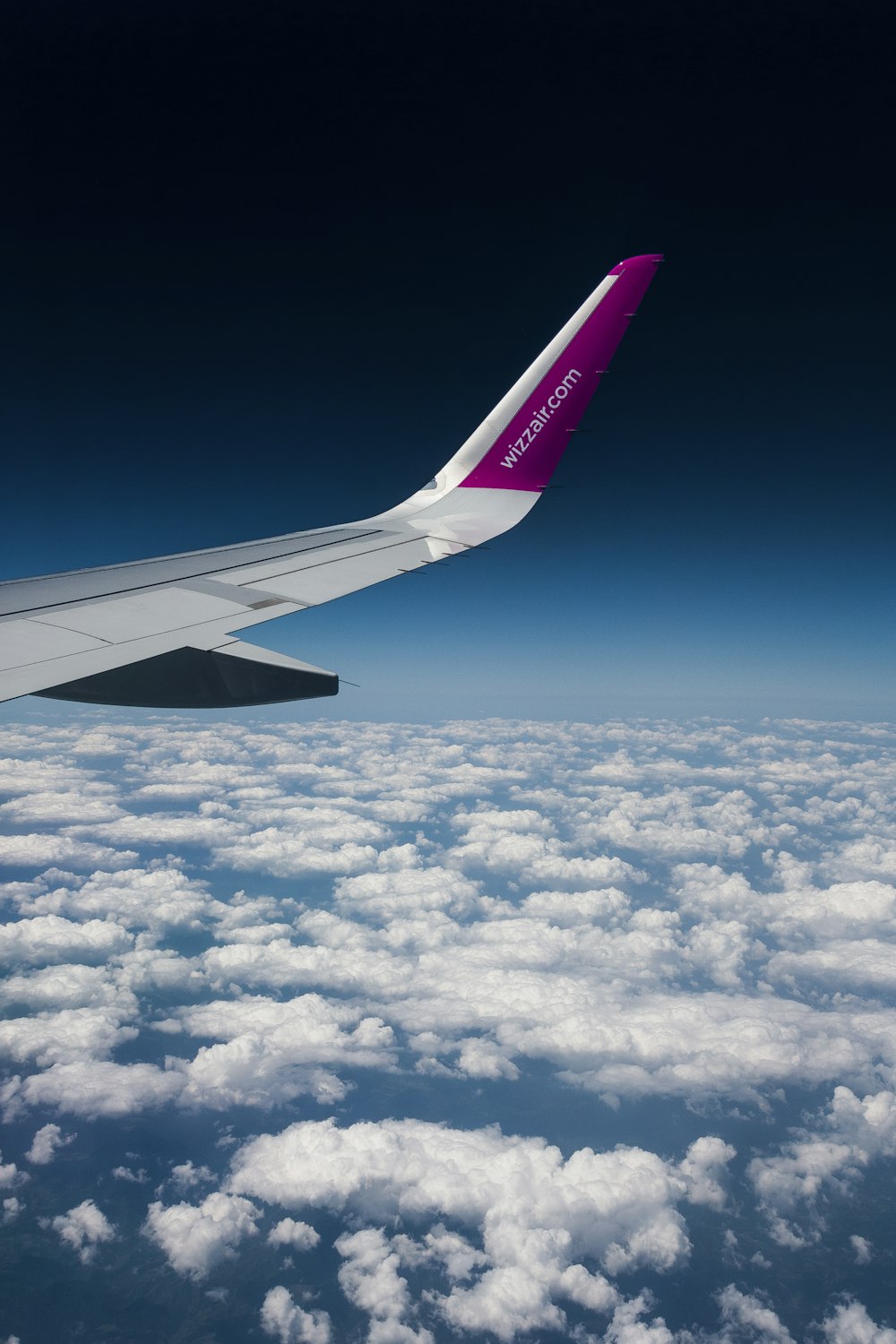 view of planes wings above clouds