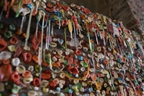A wall covered in colorful chewing gum with various colors and shapes stuck to it.