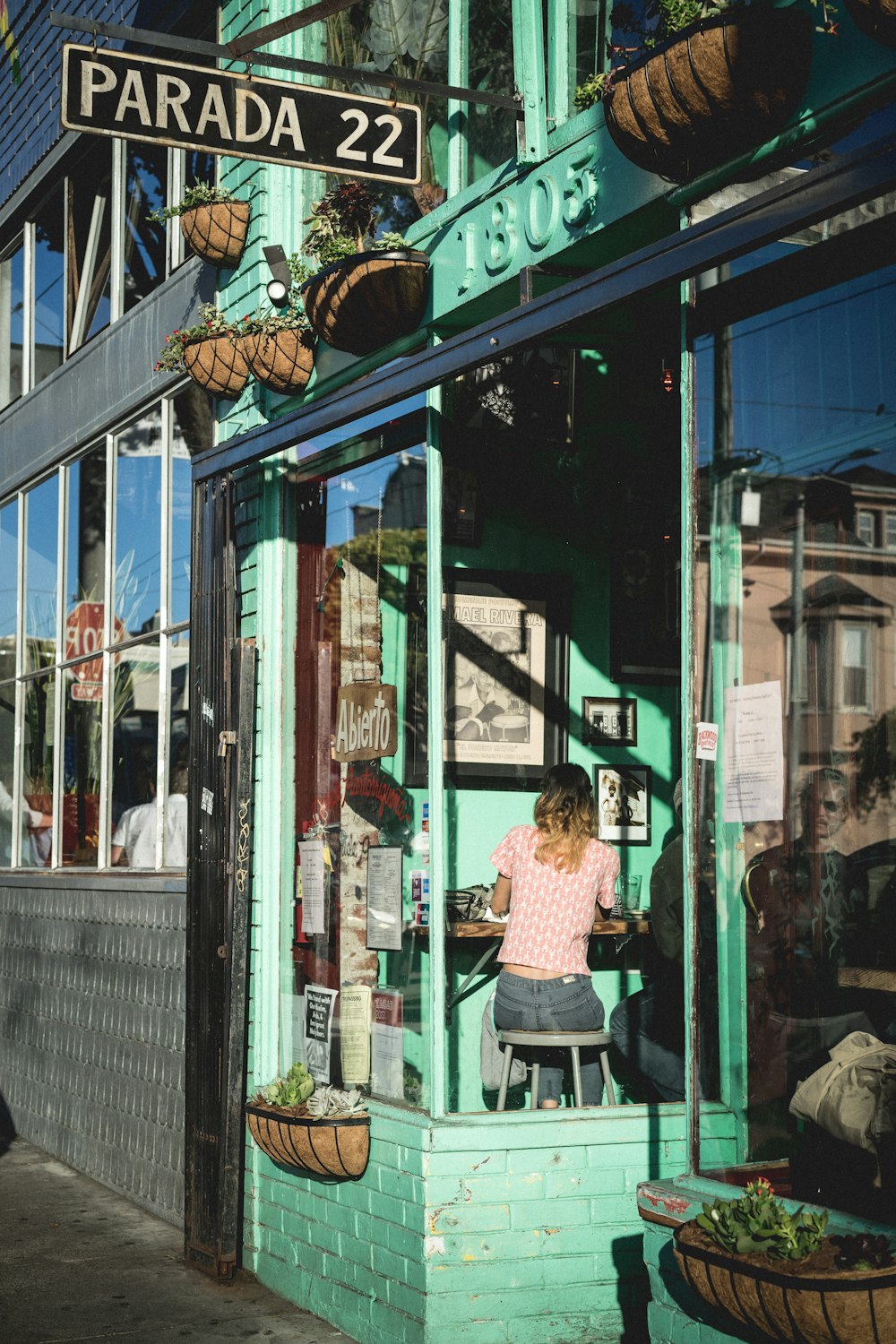 woman sitting on stool inside store