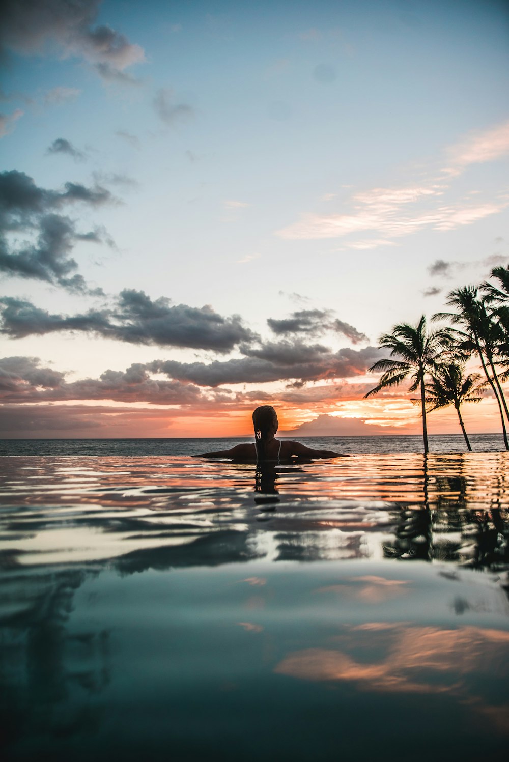 woman swimming on infinity pool