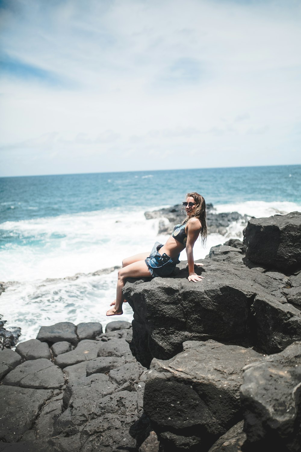 woman sitting down on rock formation