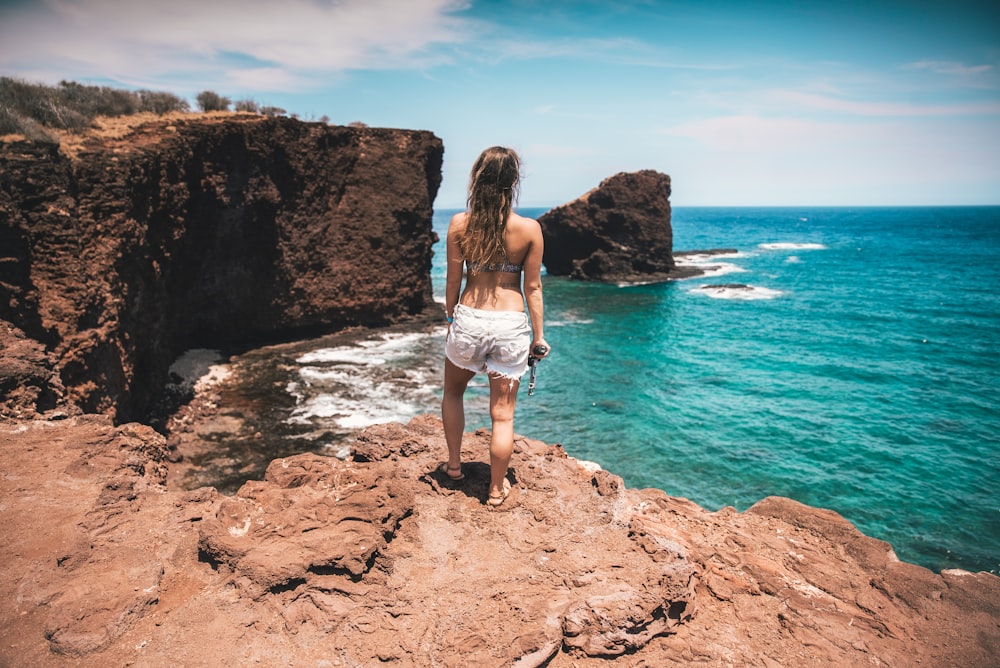 woman standing near ocean during daytime