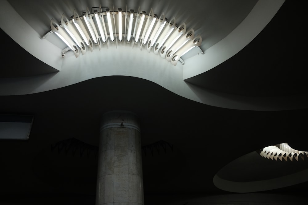 a very tall light fixture in a very dark room