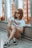 woman sitting on floor with two knees up