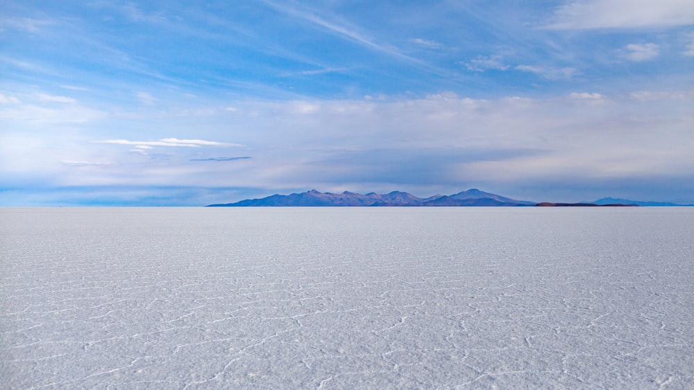 body of water under cloudy sky