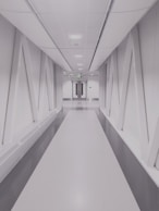 person taking photo of white and gray hallway