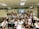 A group of happy students studying together in a classroom.