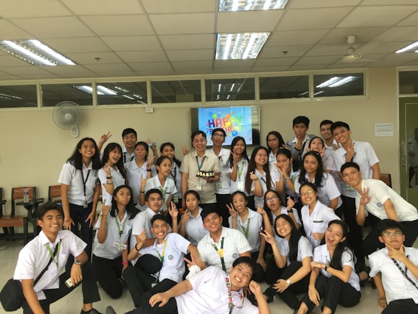 A group of students celebrating after a successful presentation in a classroom.