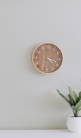 white desk lamp beside green plant