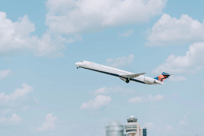 An aircraft in flight over an airport