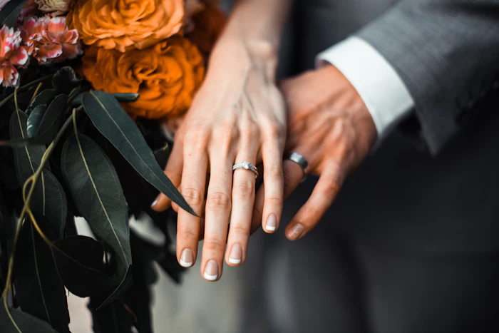 A couple's hands showing their wedding rings