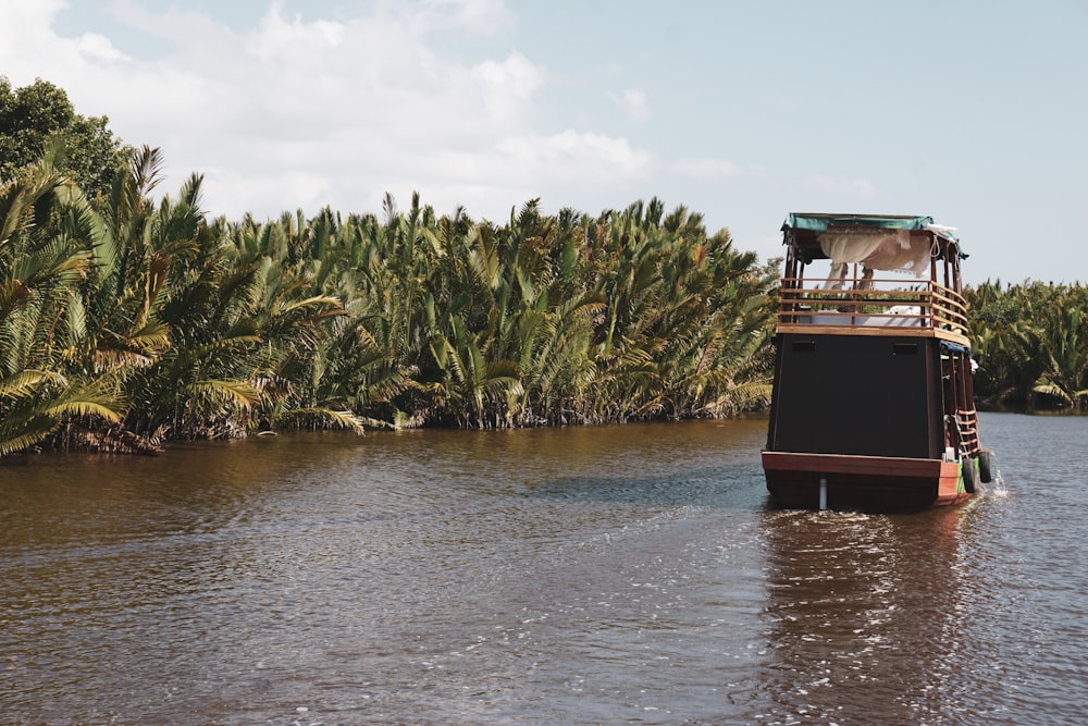 brown power boat near coconut tree