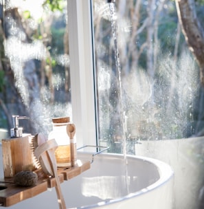 white ceramic sink beside window