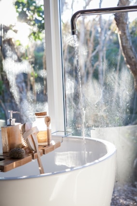 white ceramic sink beside window