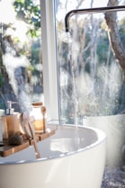 white ceramic sink beside window
