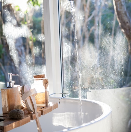 white ceramic sink beside window