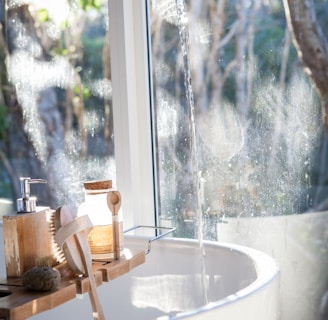 white ceramic sink beside window