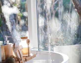 white ceramic sink beside window