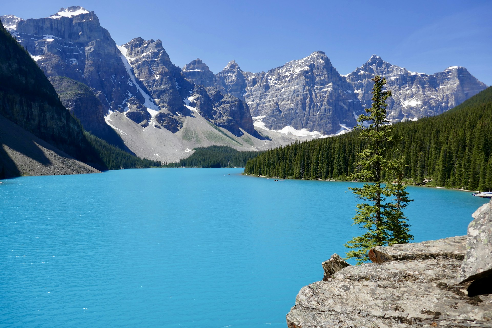 body of water surrounded by mountains and trees