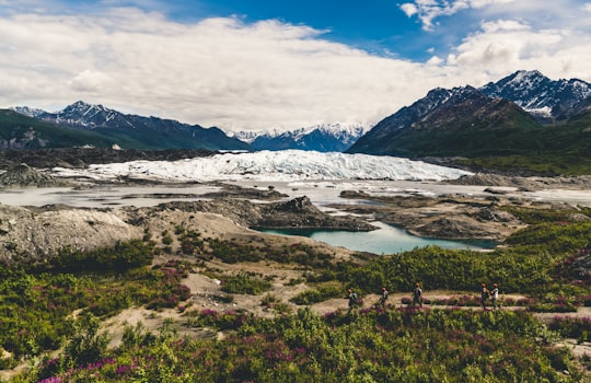 body of water at the foot of snow covered mountain during daytime in Alaska United States