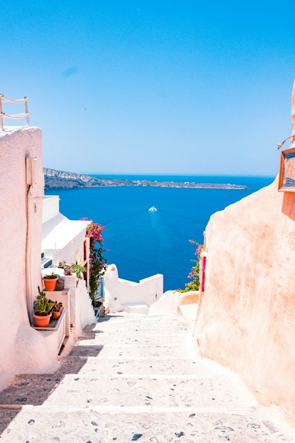 Whitewashed steps leading down towards the Aegean sea on a Greek island