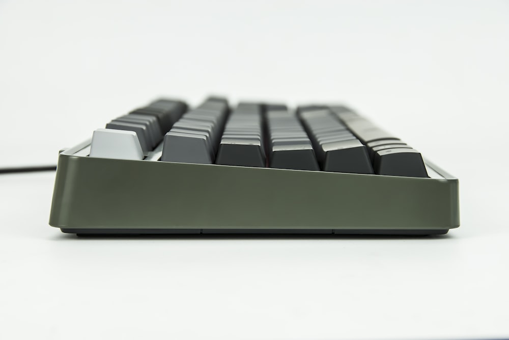 selective focus of black and gray corded computer keyboard