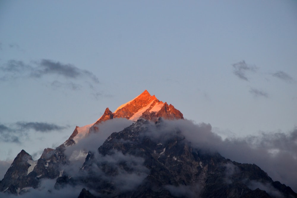 snowy mountain covered with white clouds