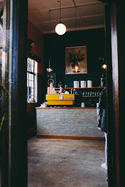 A cozy coffee shop corner filled with people chatting and enjoying steaming cups of coffee.