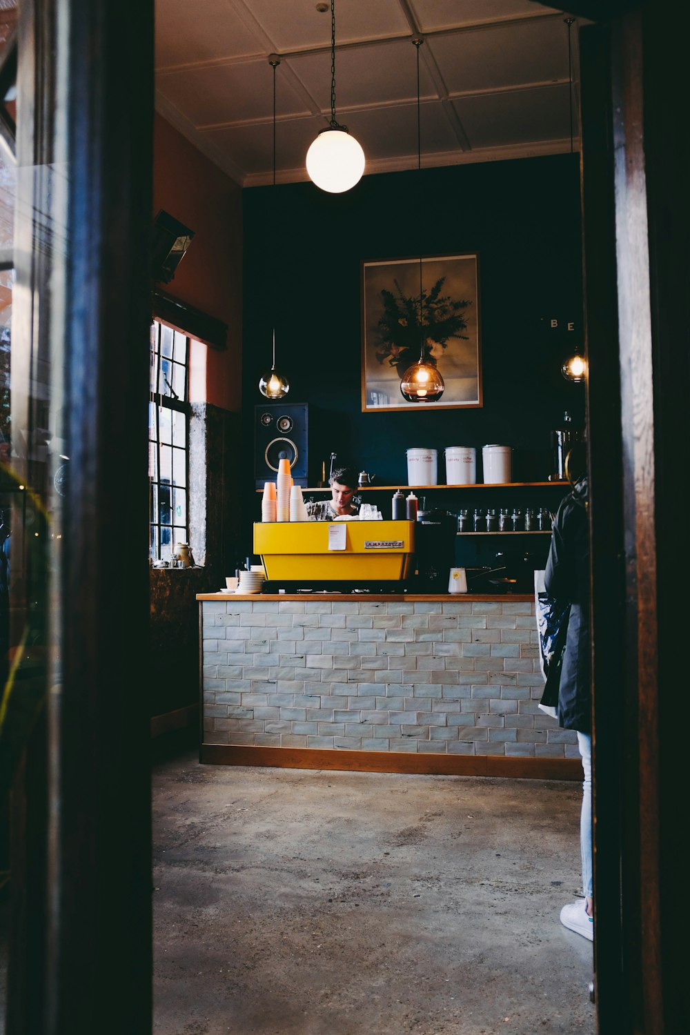 man beside a yellow table