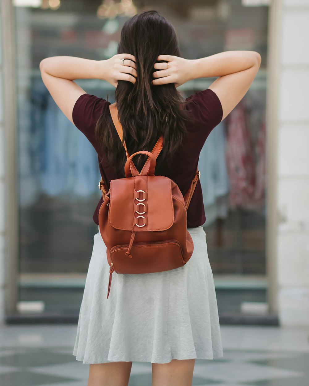 woman holding her hair with both hands