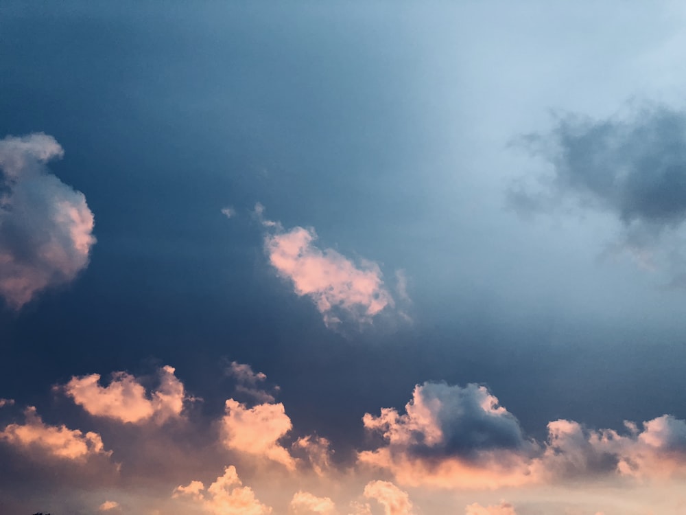 a plane flying in the sky with a lot of clouds