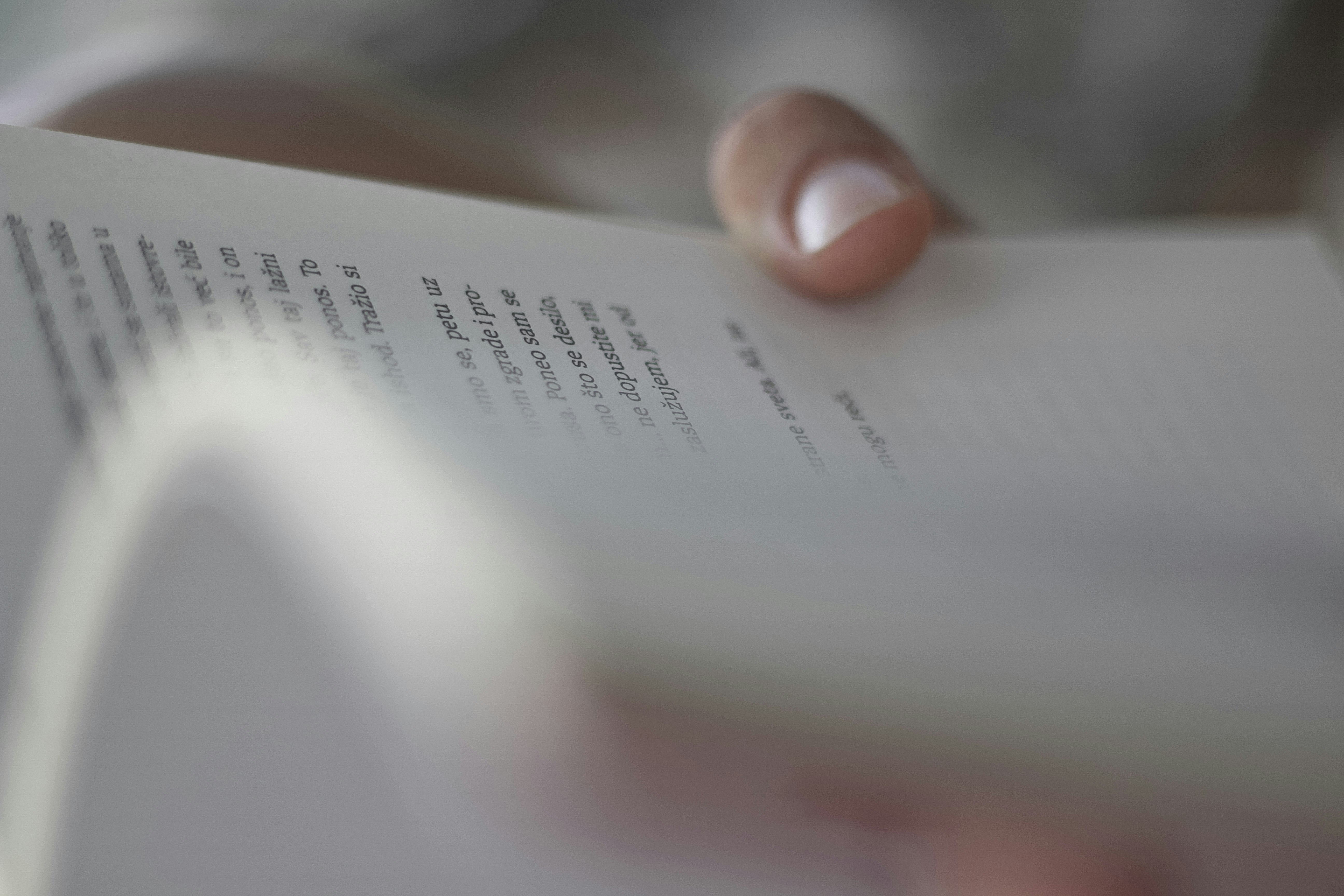 person holding white book