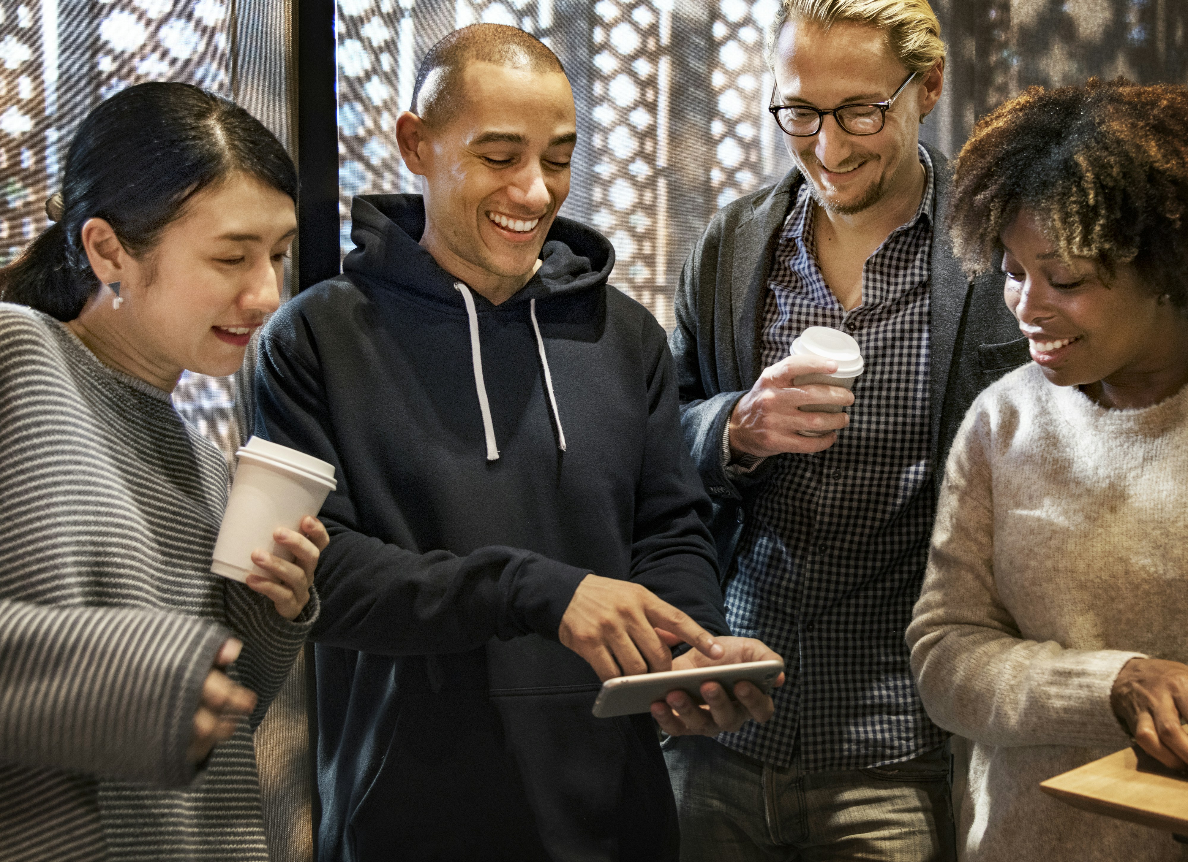 group of people looking at smartphone