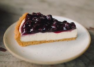 slice blueberry cheesecake pie on white ceramic plate